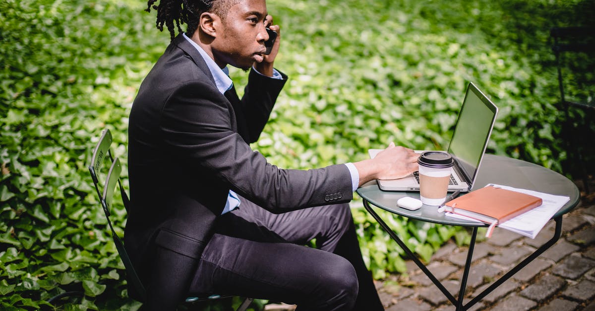 Who's the guy on the front cover of Call of Duty: Black Ops II? - Serious African American male talking on smartphone while working on laptop in summer cafe Who's the guy on the front cover of Call of Duty: Black Ops II? - Serious African American male talking on smartphone while working on laptop in summer cafe