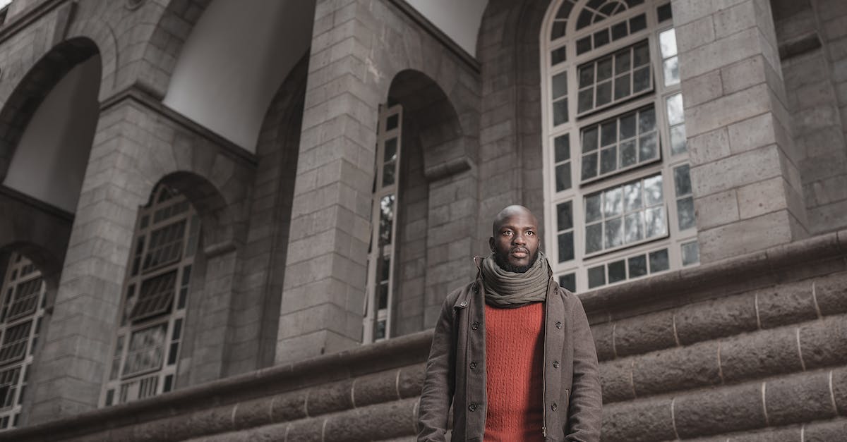 Who can I imprison in my stronghold in Pillars of Eterntity? - Man in Red Scarf and Black Pants Standing on Brown Staircase