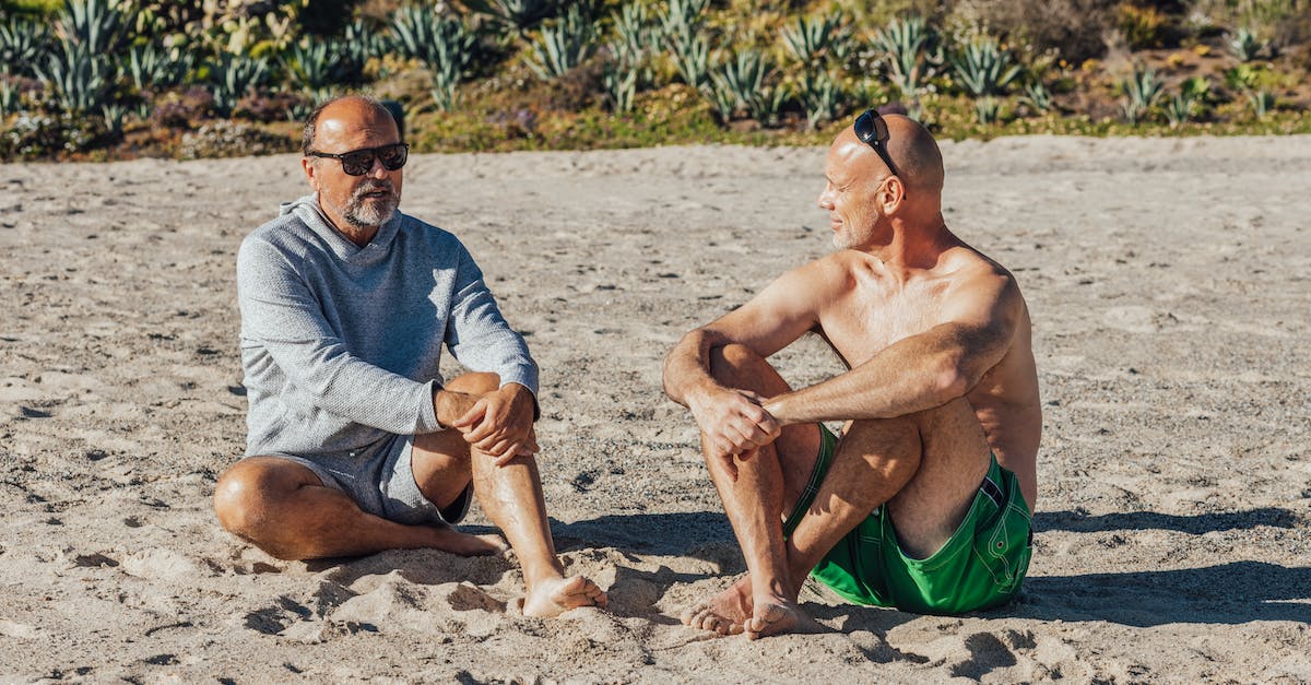 Who Counts the Days, and why? - Man in Blue and White Crew Neck Shirt Sitting on White Sand
