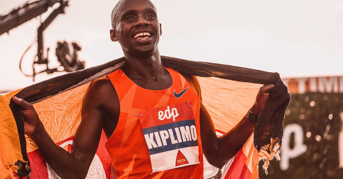 Who gets the kill when the turret 'last hits' the champion slain? - Man in Orange and White Tank Top Holding Brown Wooden Bar