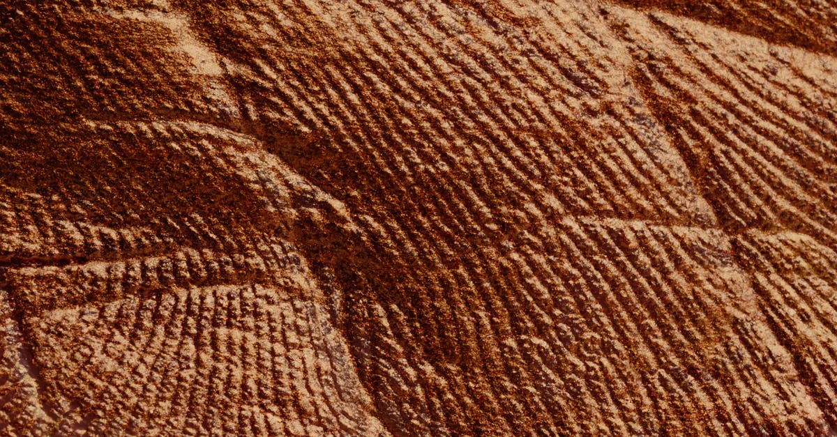 Who invented directional damage indicator [closed] - Closeup of abstract rough textured parget surface of brown color with cracks