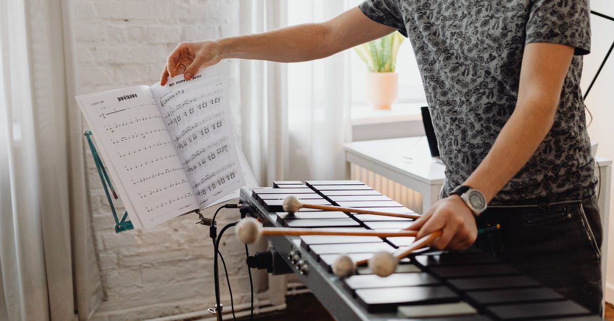 Who is the composer for DBFZ? - Man Holding Sheet Music and Mallets Who is the composer for DBFZ? - Man Holding Sheet Music and Mallets