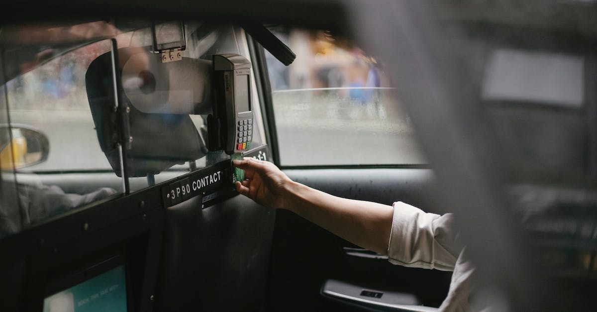 Who pays for the destruction of an insured car in GTA Online? - Side view of crop faceless male passenger sitting on backseat and using credit card reader to pay for trip in taxi