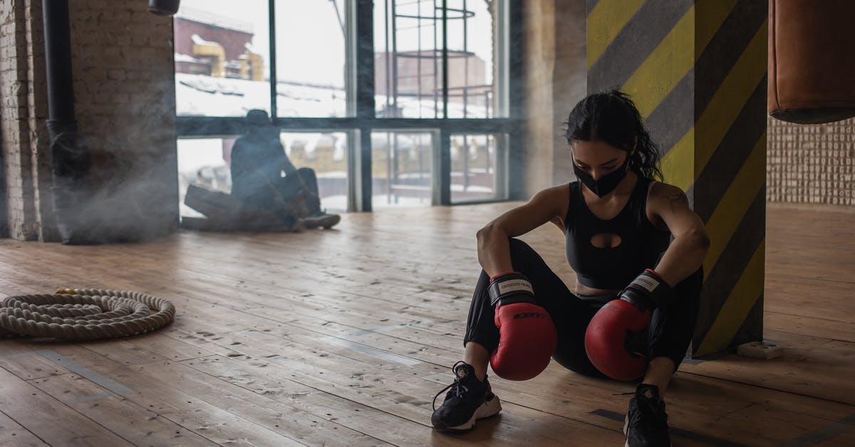 Who to battle when first able to access gyms? - Tired black boxer resting on floor in gym Who to battle when first able to access gyms? - Tired black boxer resting on floor in gym