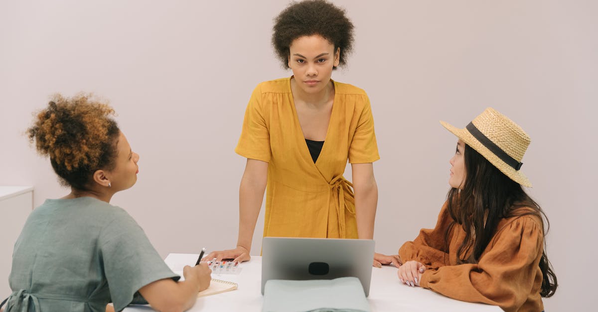 Who will be the leader if 6 colonels are in the same squad? - Man and Woman Sitting at Table Using Macbook