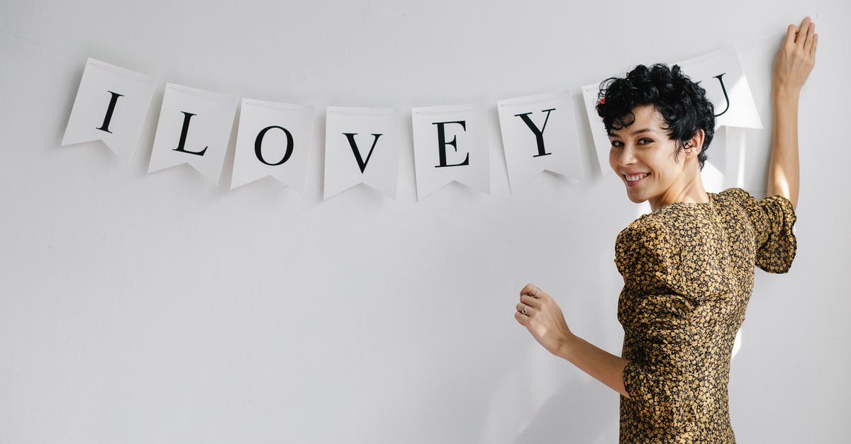 Why am I moving slowly when I'm not over-encumbered? - Happy woman decorating wall with inscription I Love You