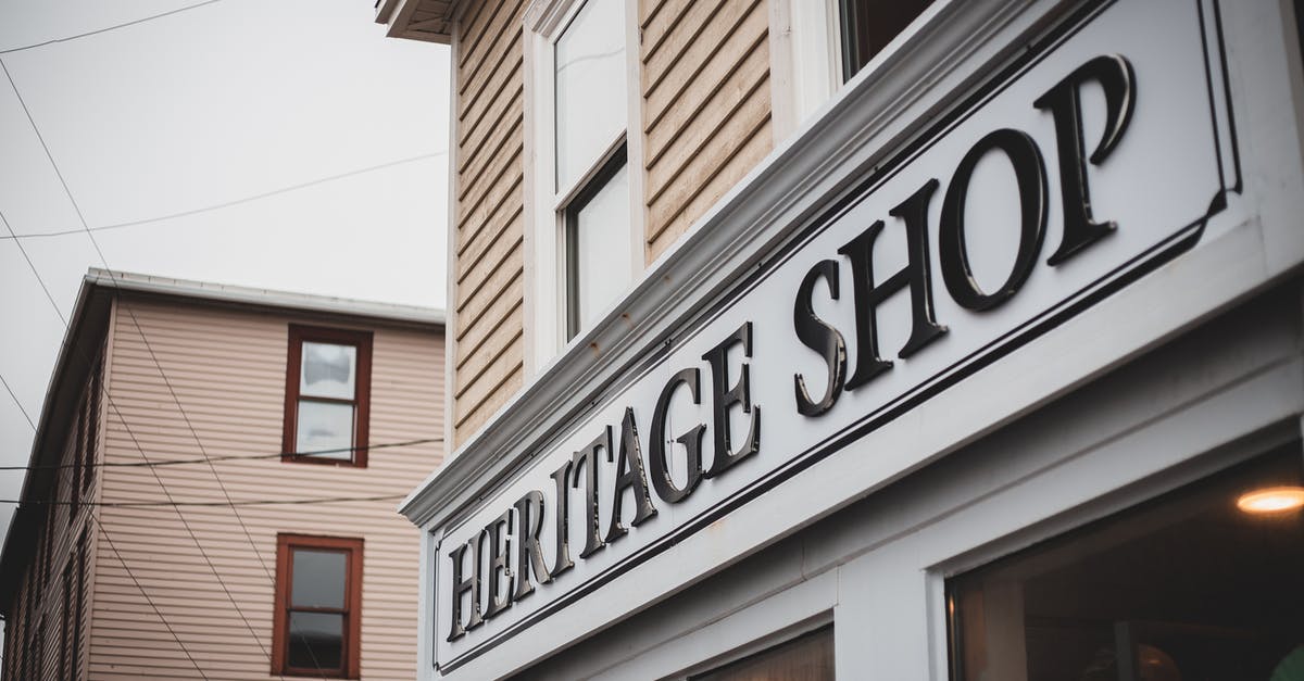 Why am I unable to purchase a tile outside of my current cultural area? - House with gift shop and signboard located on street with residential building against cloudless sky and power line in town