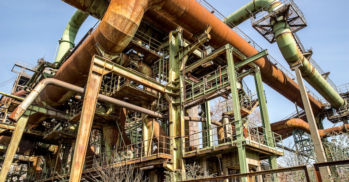 Why are pipes rusting and bursting - Low Angle View of an Old Industrial Site with Rusted Pipes