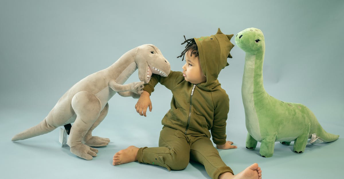 Why aren't Atlas and P-Body good enough for GLaDOS? [Spoilers] - African American child with dreadlocks in dinosaur costume sitting between soft toys representing bite concept