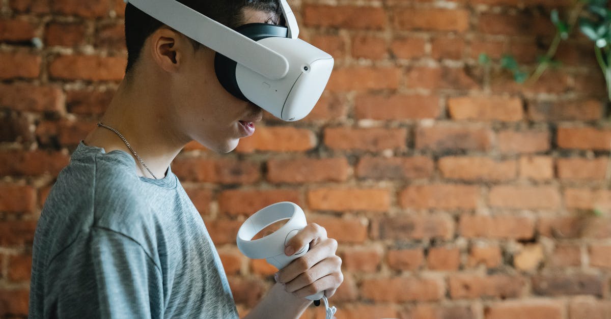 Why can't I assign a second controller in PES 2016 multiplayer? - Concentrated man using VR device Why can't I assign a second controller in PES 2016 multiplayer? - Concentrated man using VR device