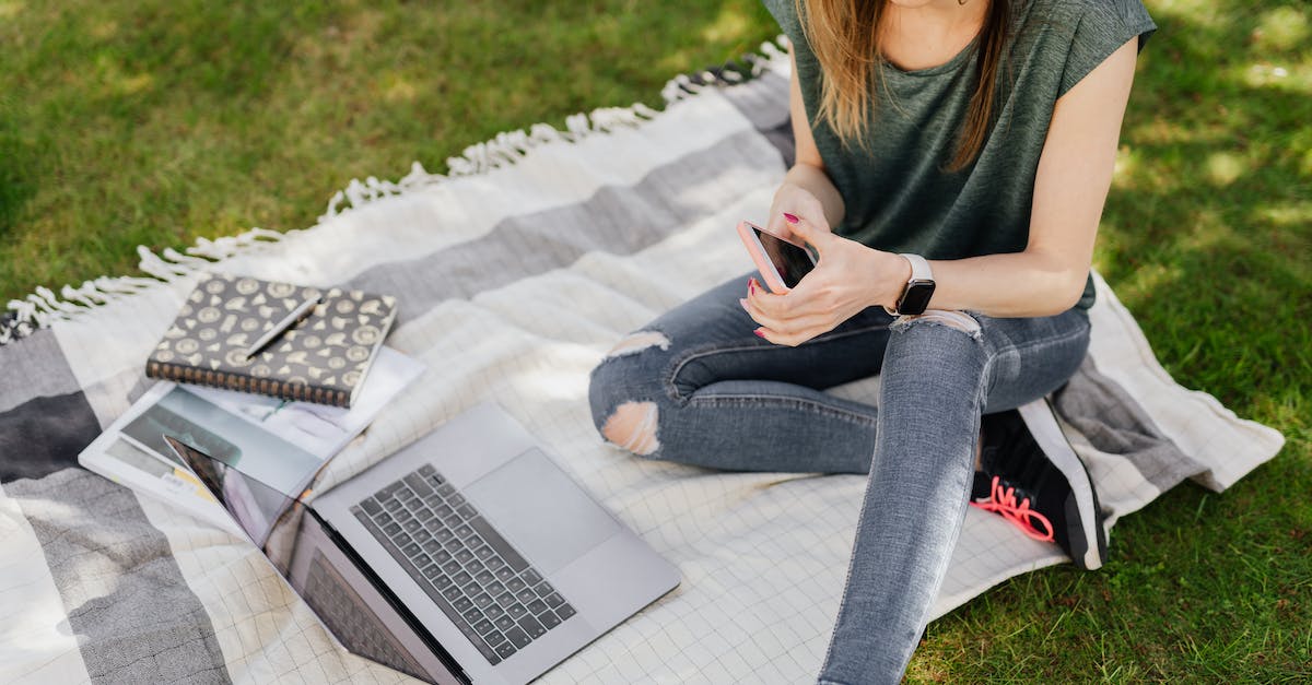 Why can't I break bedrock on my Spigot server? - From above of young crop female student in casual clothes surfing social media on smartphone while sitting with laptop and notebooks on blanket placed on green grass in sunny park