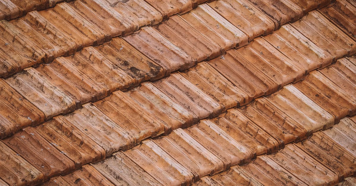 Why can't I build anything on these tiles? - From above of grunge weathered textured surface of roof tiles of aged building Why can't I build anything on these tiles? - From above of grunge weathered textured surface of roof tiles of aged building