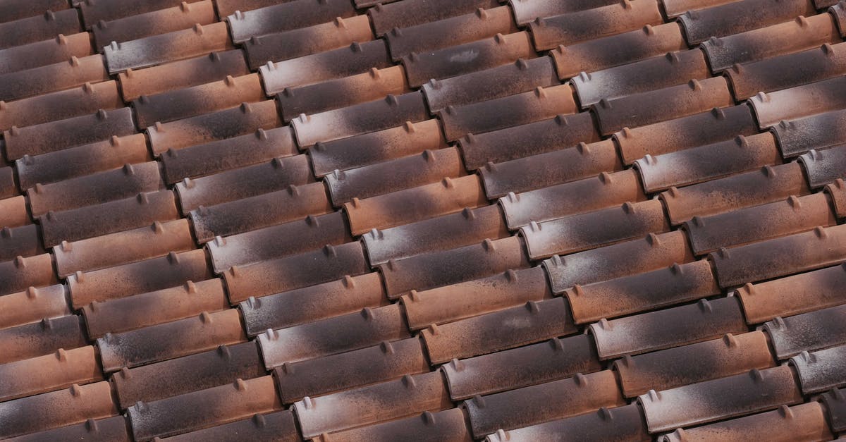 Why can't I build anything on these tiles? - From above of shabby roof of house with tiled acute angled cross slab Why can't I build anything on these tiles? - From above of shabby roof of house with tiled acute angled cross slab