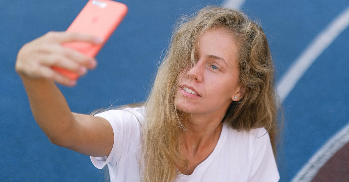 Why can't I capture my first Pokemon? - Lady using smartphone for photo on court