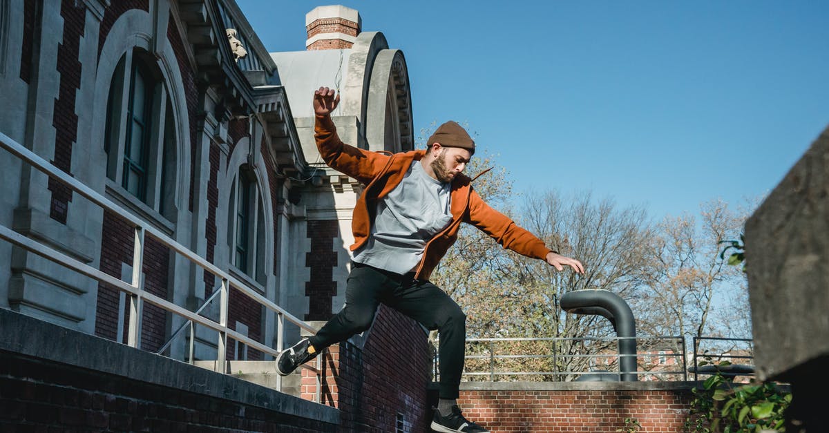 Why can't I destroy this energy barrier with my melee attack? - Energetic man jumping from wall in town