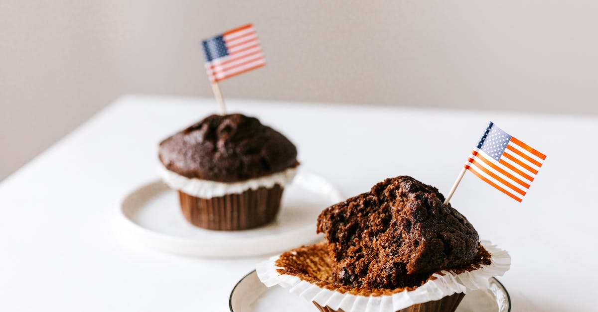 Why can't I eat cake in Minecraft pe? - From above of bitten and whole festive chocolate cupcakes decorated with miniature american flags and placed on white table