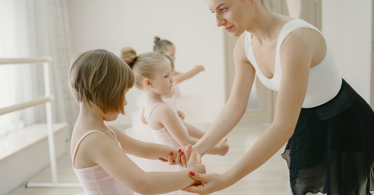 Why can't I find dominator on mage class on rift? - Woman in White Tank Top and Blue Denim Jeans Holding Baby in White Tank Top