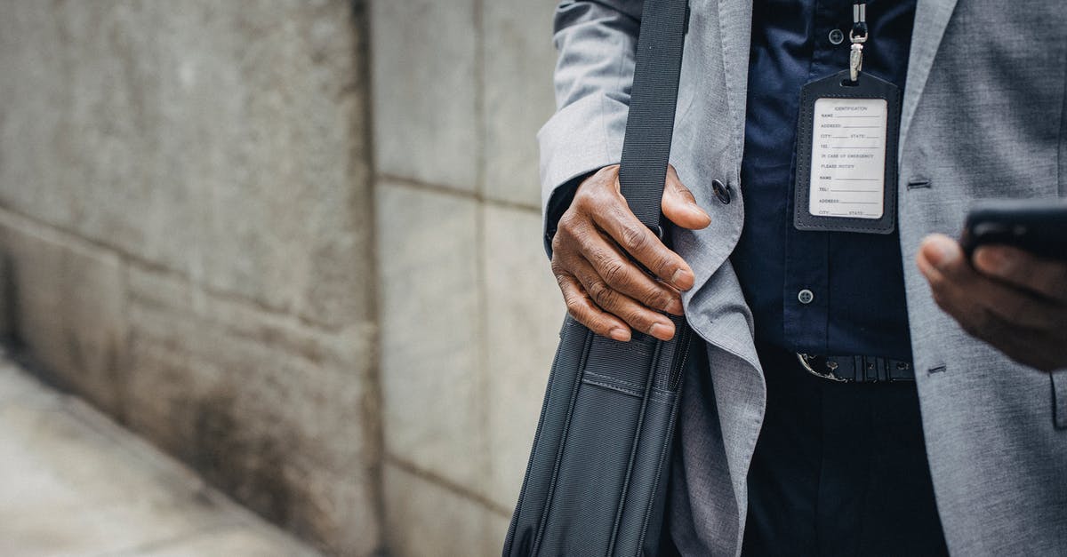 Why can't I force Football Manager 2017 to use the Nvidia graphics card? - Crop anonymous African American entrepreneur in gray jacket with satchel and pass card browsing internet on smartphone on pavement near stone wall in city in daylight