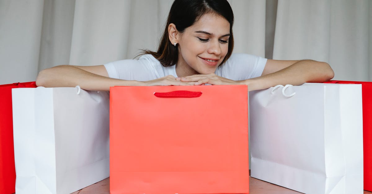 Why can't I gift an item? - Excited young female leaning on shopping bags and smiling happily
