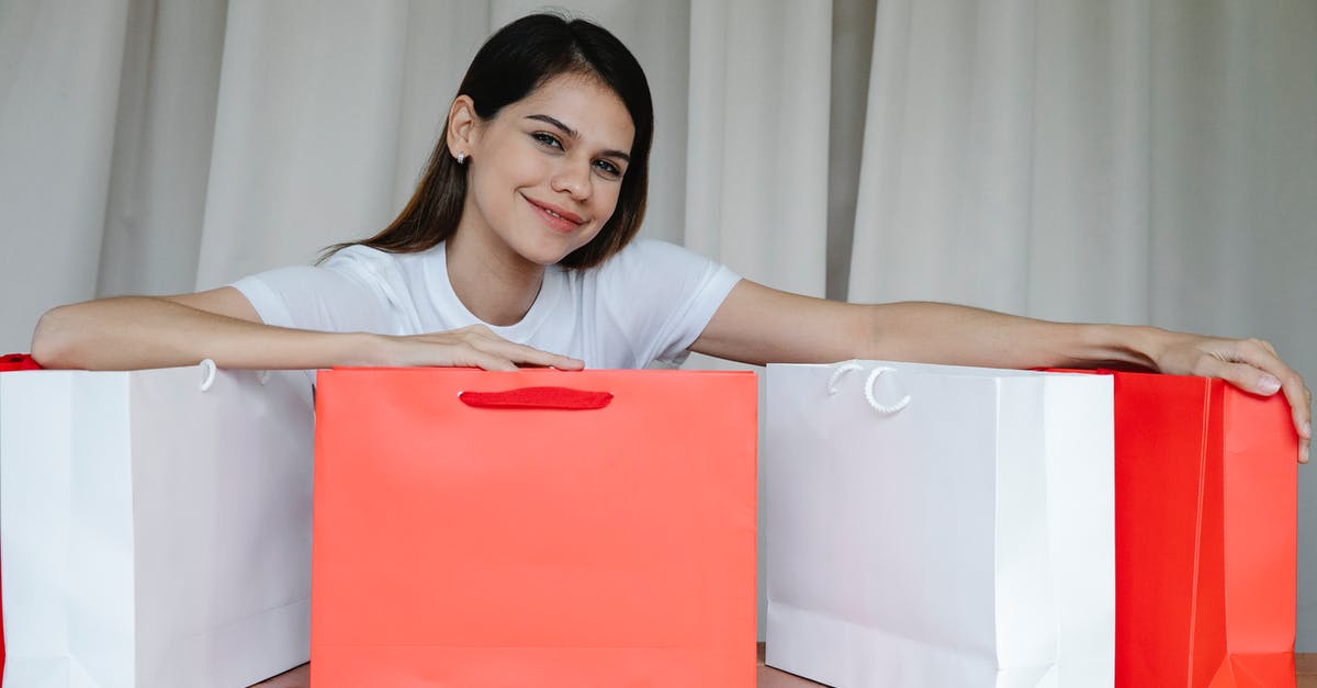 Why can't I gift an item? - Delighted young woman showing purchases in paper bags and smiling