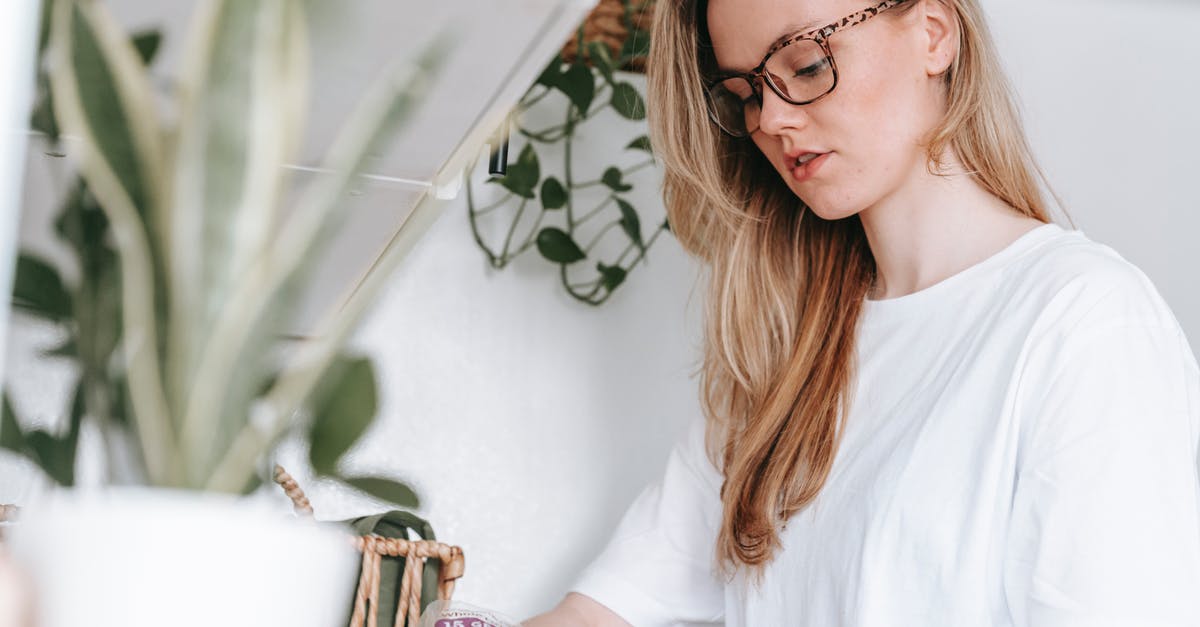 Why can't I make blueprints? - Low angle of focused female in eyeglasses and home t shirt standing at counter with green potted plants while cooking lunch snack at home Why can't I make blueprints? - Low angle of focused female in eyeglasses and home t shirt standing at counter with green potted plants while cooking lunch snack at home