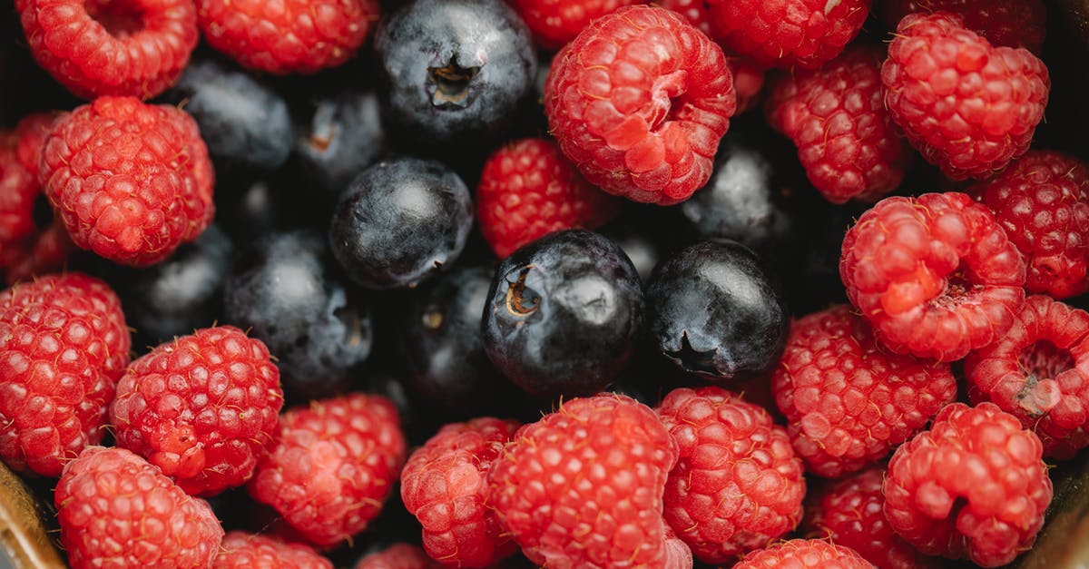 Why can't I pick up these corpses? - Closeup heap of delicious fresh raspberries and blueberries picked from garden placed in bowl during harvest season in summer Why can't I pick up these corpses? - Closeup heap of delicious fresh raspberries and blueberries picked from garden placed in bowl during harvest season in summer