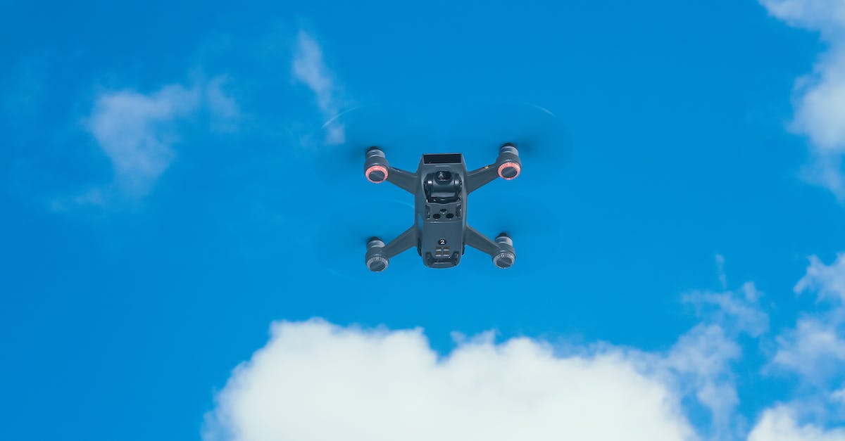 Why can't I power up my drone system? - Modern UAV against blue sky with clouds Why can't I power up my drone system? - Modern UAV against blue sky with clouds
