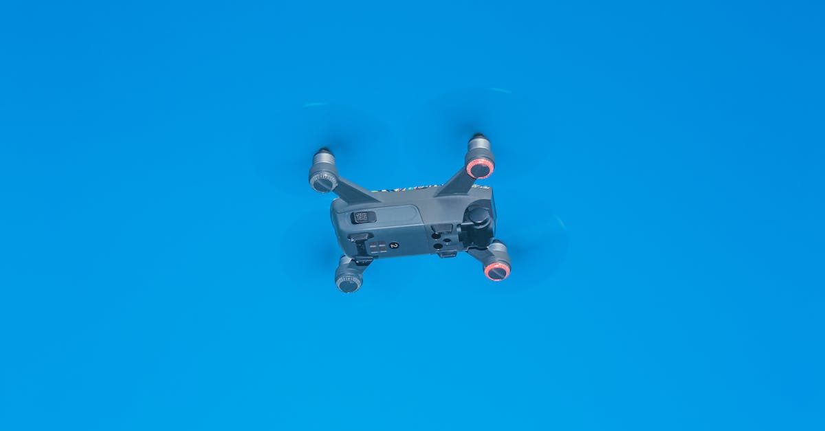 Why can't I power up my drone system? - From below of side part of remote control drone with quickly spinning propellers and small cameras for taking photos and videos Why can't I power up my drone system? - From below of side part of remote control drone with quickly spinning propellers and small cameras for taking photos and videos