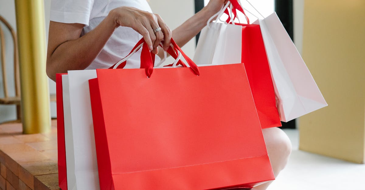 Why can't I purchase Pokécoins? - Side view of crop anonymous female buyer in white t shirt sitting on bench with many shopping bags in daylight