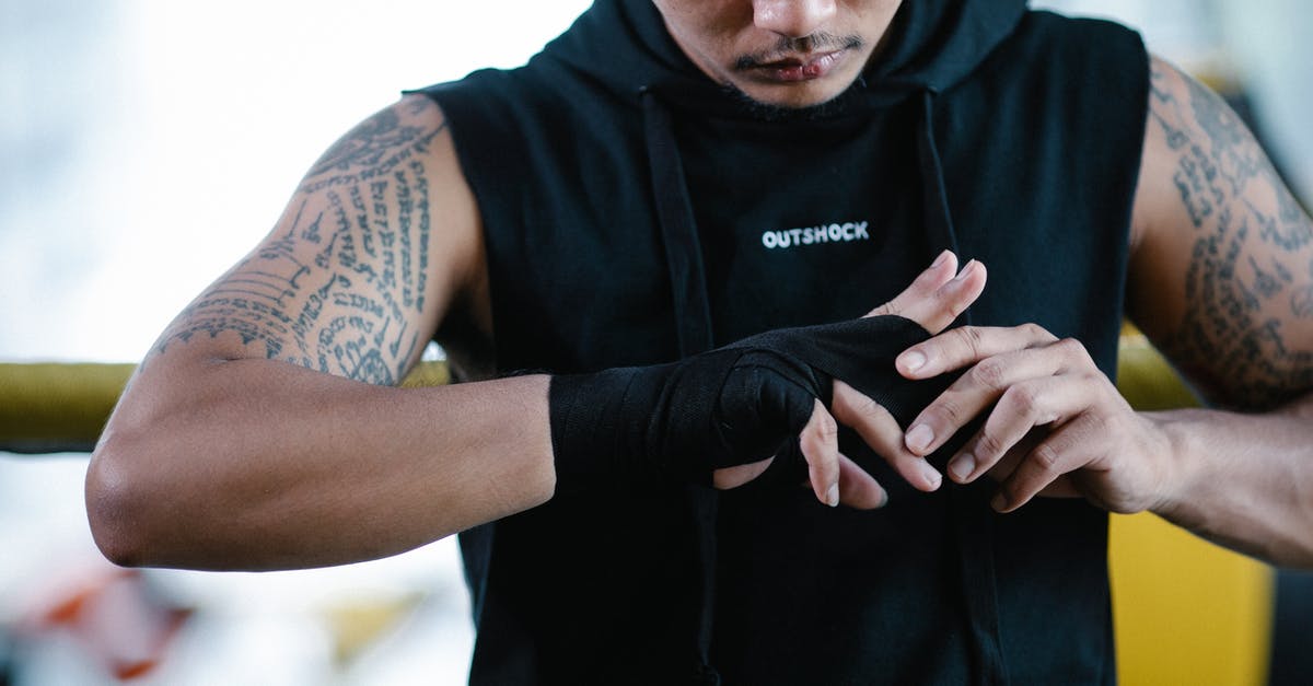 Why can't I see any gym or pokestop - Brutal ethnic boxer bandaging hand in gym