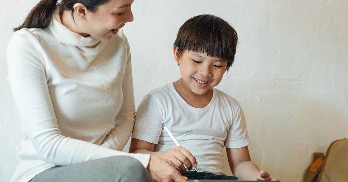 Why can't I see or share replays in Clash of Clans? - Crop happy ethnic mother sharing tablet with son at home