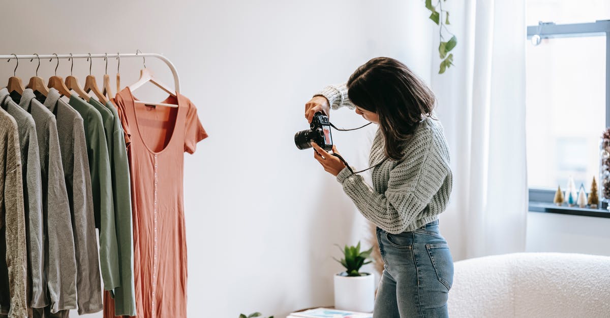 Why can't I see the Pokémon in a live camera mode? - Side view of young female photographer in casual outfit standing in front of hanger and taking picture with camera of shirt in modern apartment Why can't I see the Pokémon in a live camera mode? - Side view of young female photographer in casual outfit standing in front of hanger and taking picture with camera of shirt in modern apartment