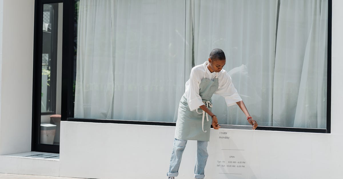 Why can't I see/sell things on the farmers board - Diligent black female worker setting signboard outside cafeteria at sunny day