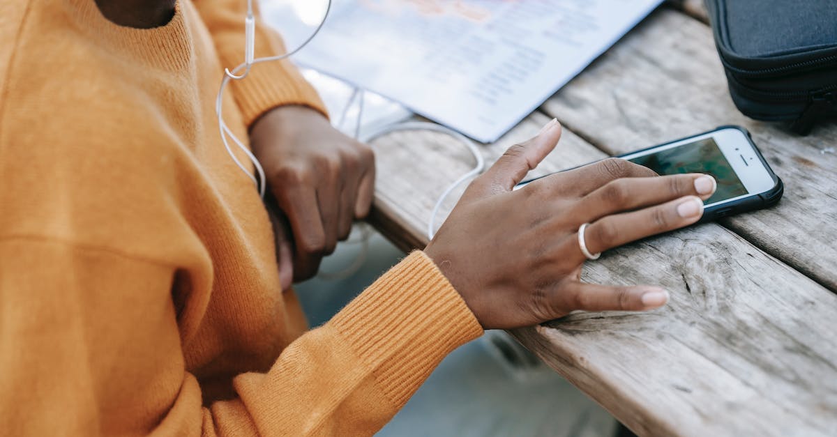 Why can't I send messages to my friends? - Black woman touching screen of smartphone at table