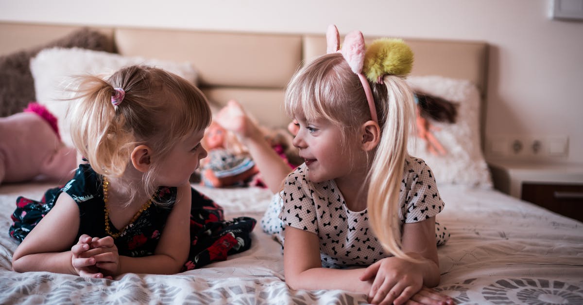 Why can't I spend time in bed? - Cute little sisters resting on bed and chatting Why can't I spend time in bed? - Cute little sisters resting on bed and chatting