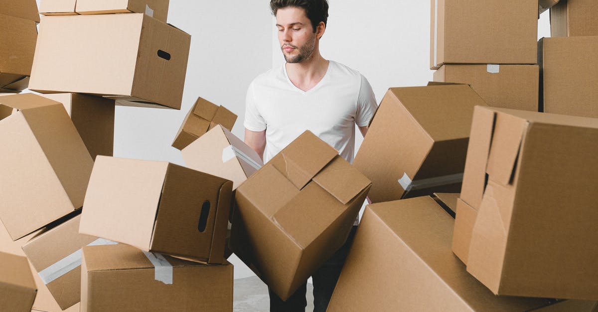 Why can't I stack my Experience Scrolls? - Man between stacks of cardboard boxes at home