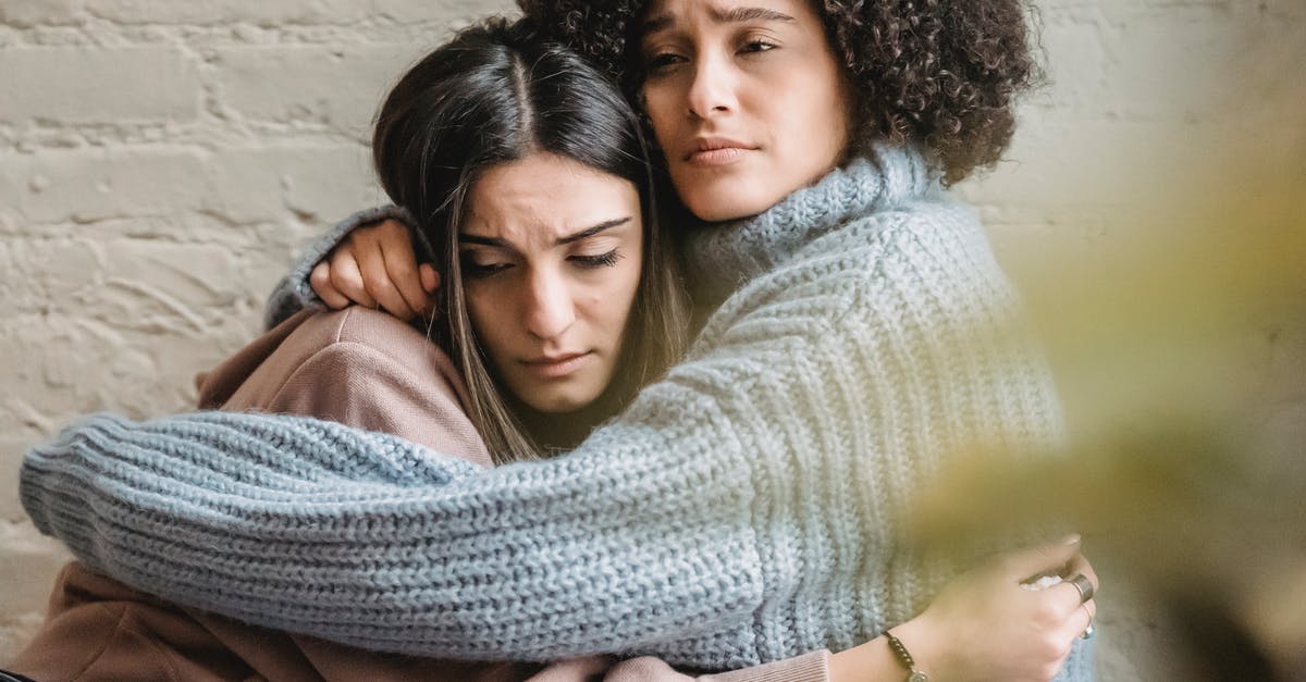 Why can't I summon my friend to help me? - Depressed diverse women hugging near wall