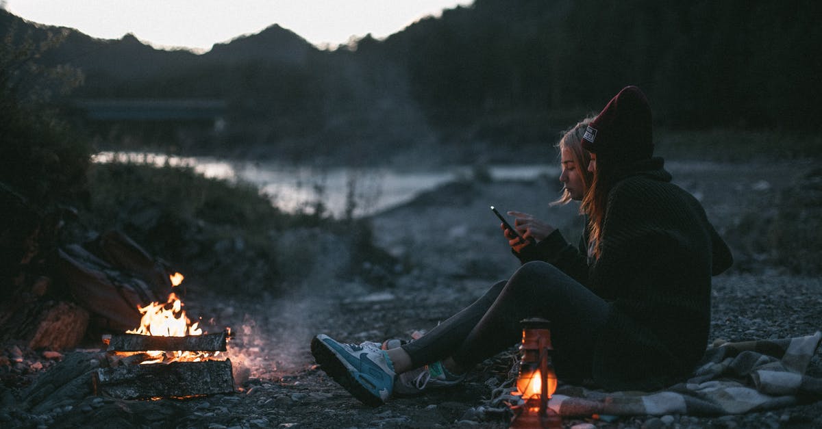 Why can't I use Fire Bombs? - Side view of young girlfriends resting on shore of river near campfire while using smartphone in evening Why can't I use Fire Bombs? - Side view of young girlfriends resting on shore of river near campfire while using smartphone in evening