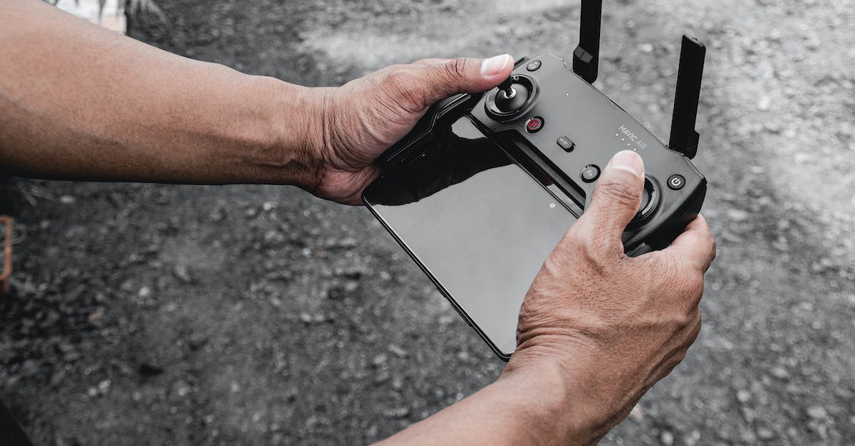 Why can't my relay antenna control my drone? - Hands of Person Holding Black Controller Why can't my relay antenna control my drone? - Hands of Person Holding Black Controller