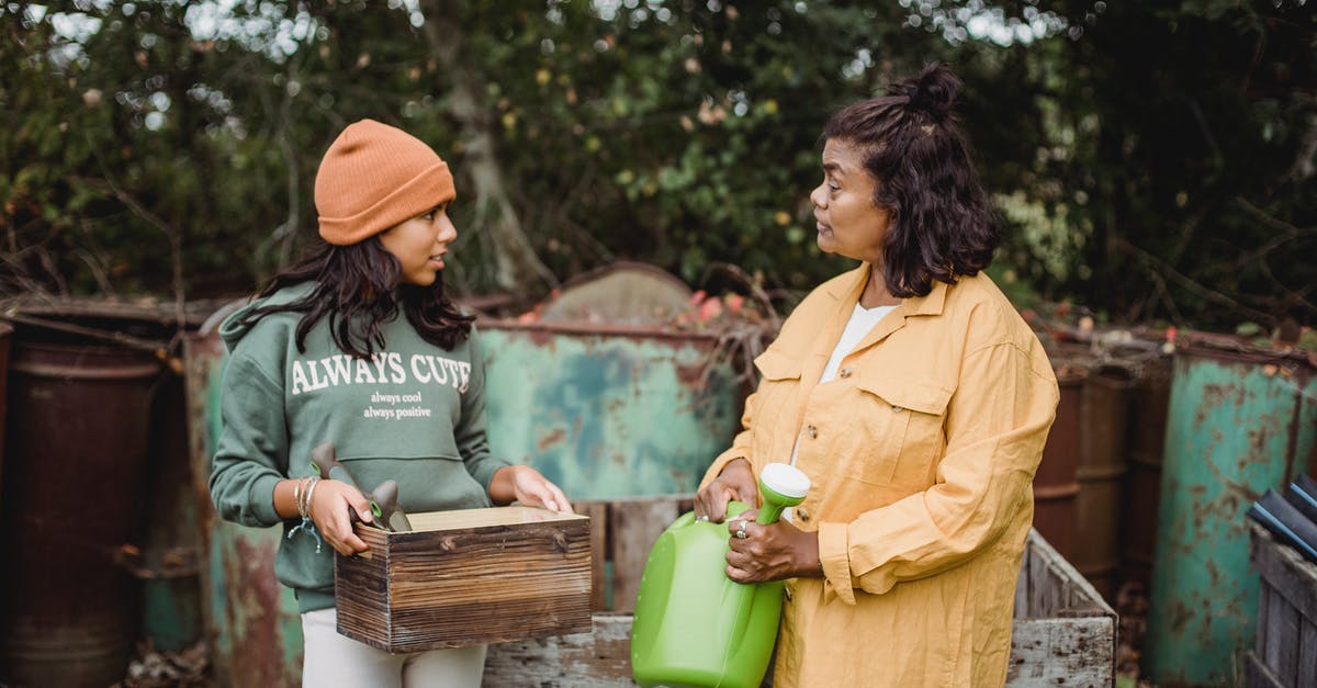 Why Can't the Mother be Returned to the Heavens? (Spoilers) - Ethnic woman with watering can speaking with teen near metal containers while looking at each other on farm Why Can't the Mother be Returned to the Heavens? (Spoilers) - Ethnic woman with watering can speaking with teen near metal containers while looking at each other on farm