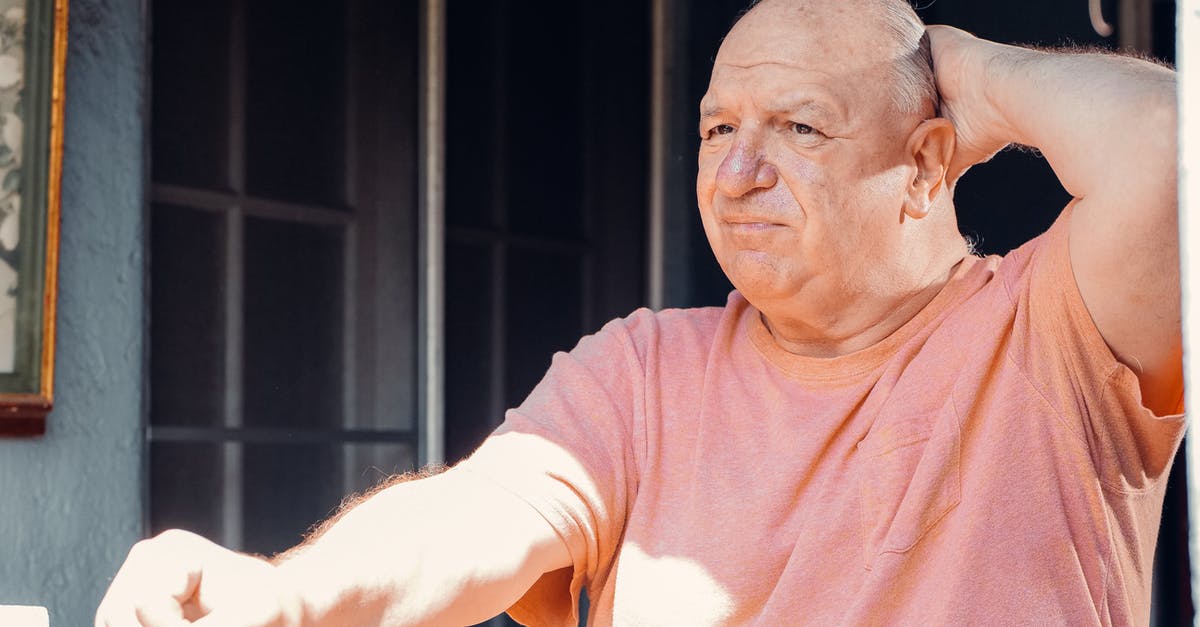 Why citizens are unhappy? - An Elderly Man Looking Outside with His Hand on His Head