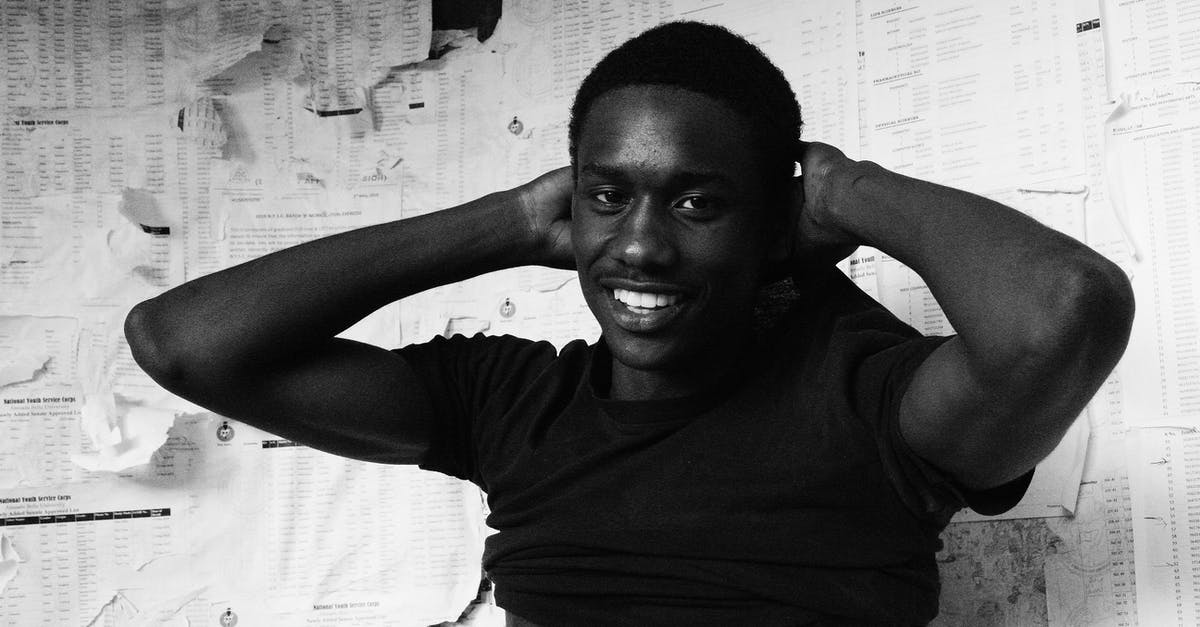 Why did all my cool power armors turn into rusty T-45's? - Black and white of cheerful provocative male standing near paper wall and taking off t shirt while looking at camera Why did all my cool power armors turn into rusty T-45's? - Black and white of cheerful provocative male standing near paper wall and taking off t shirt while looking at camera