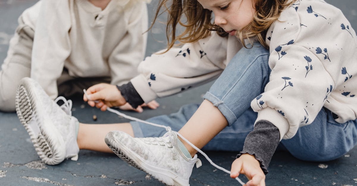 Why did the WAU try to 'repair' Johan Ross? - Crop girl tying shoelaces on playground Why did the WAU try to 'repair' Johan Ross? - Crop girl tying shoelaces on playground