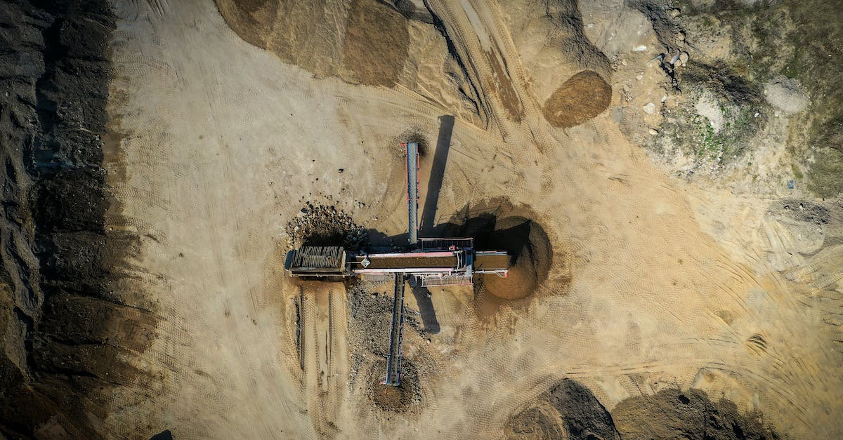 Why did this explosion make me fat? (A land mine increased my weight) - Aerial view of old sand mining construction build on sandy hilly terrain in daylight Why did this explosion make me fat? (A land mine increased my weight) - Aerial view of old sand mining construction build on sandy hilly terrain in daylight