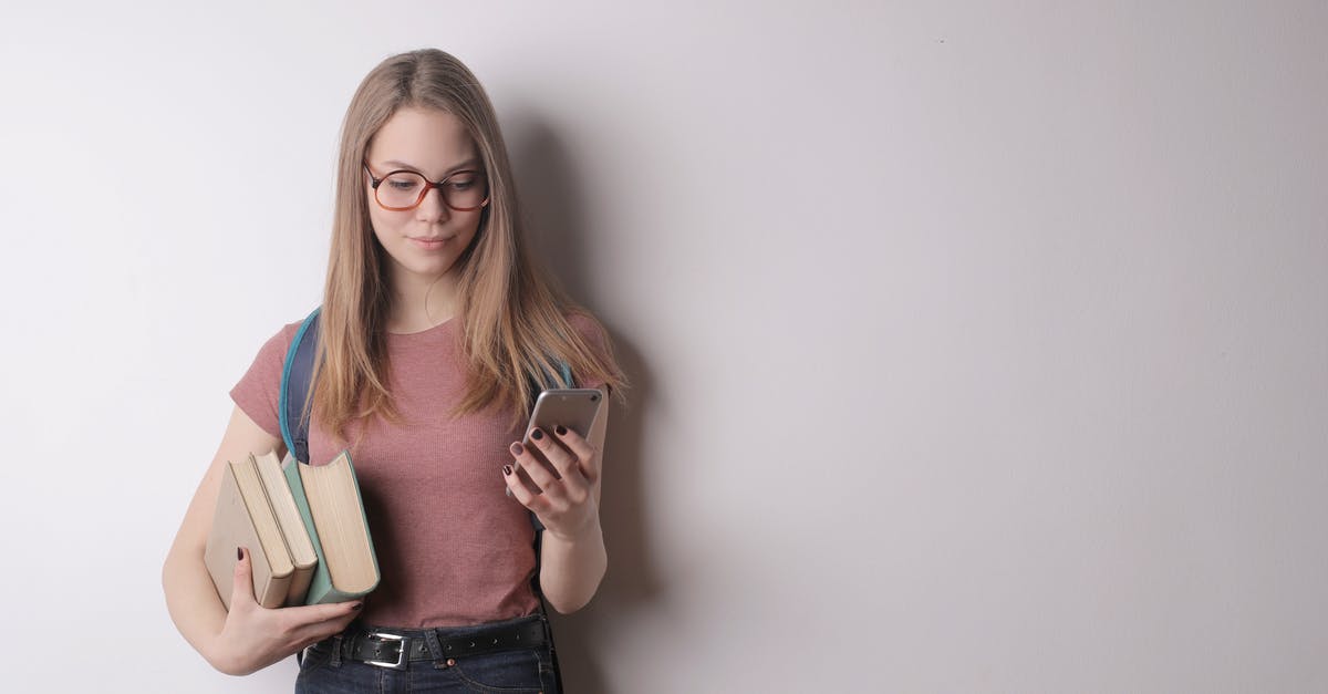 Why didn't the compass take me to where I last slept? [duplicate] - Confident intelligent female student in eyeglasses wearing pink t shirt and black jeans using cellphone while taking books standing against gray wall