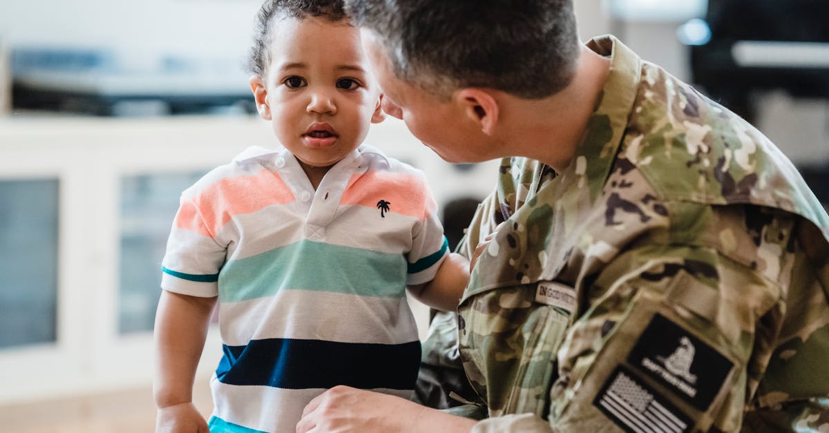 Why do adult soldiers stay under for longer compared to child soldiers? [closed] - Man in Uniform Talking to a Little Boy