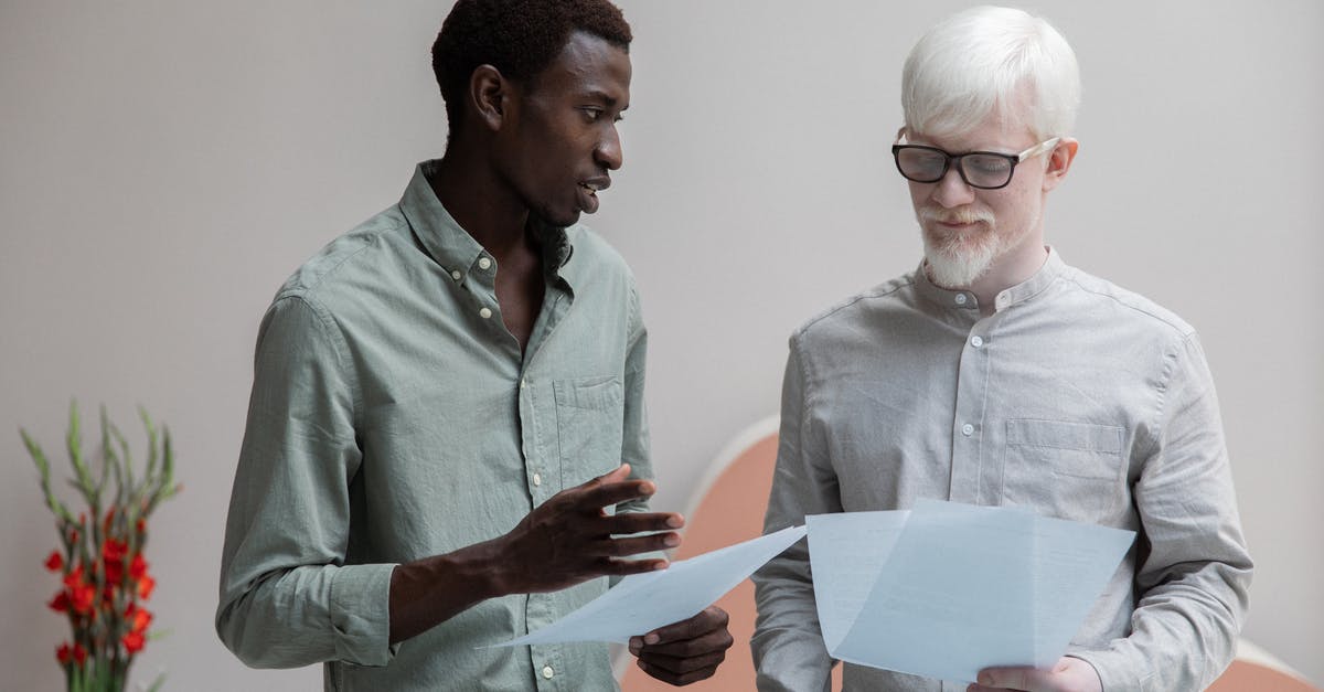 Why do different codes work to get the secret ending in INSIDE? - Concentrated African American man and albino coworker in eyeglasses working with papers while discussing work in contemporary office with flower