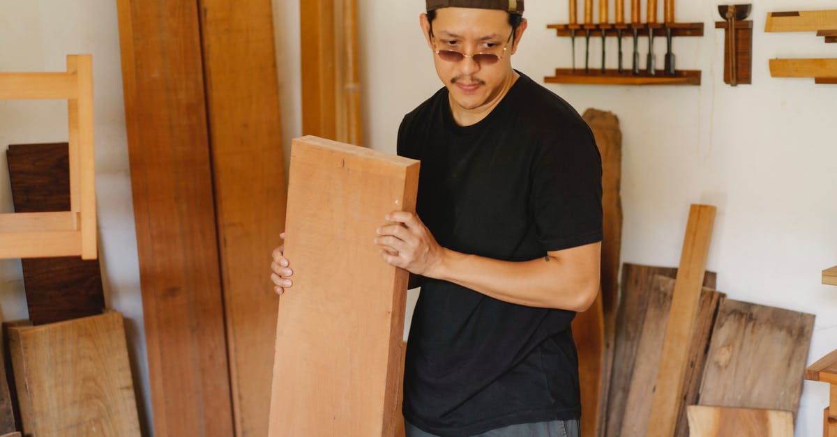 Why do dwellers think they can't carry 100 items? - Asian man carrying wooden plank and thinking Why do dwellers think they can't carry 100 items? - Asian man carrying wooden plank and thinking