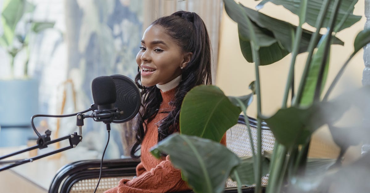Why do I sing to my plants? - Happy young black woman singing during radio program Why do I sing to my plants? - Happy young black woman singing during radio program