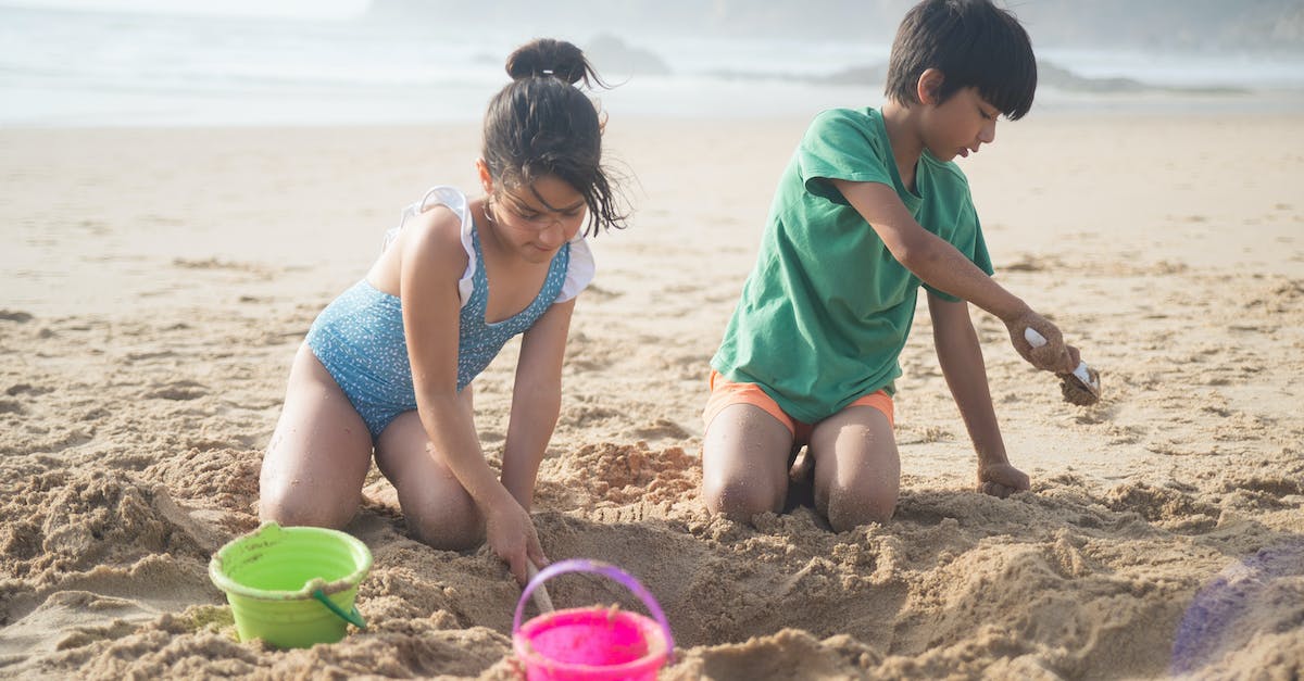 Why do residents keep digging holes on the beach? - Kid Digging on Beach Sand